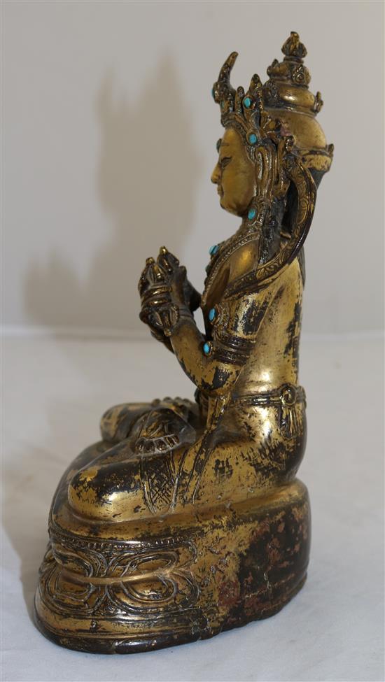 A Nepalese gilt copper alloy jewelled figure of Vajradhara, early Malla period, 15th century, height 20.3cm, later paste and stone ca